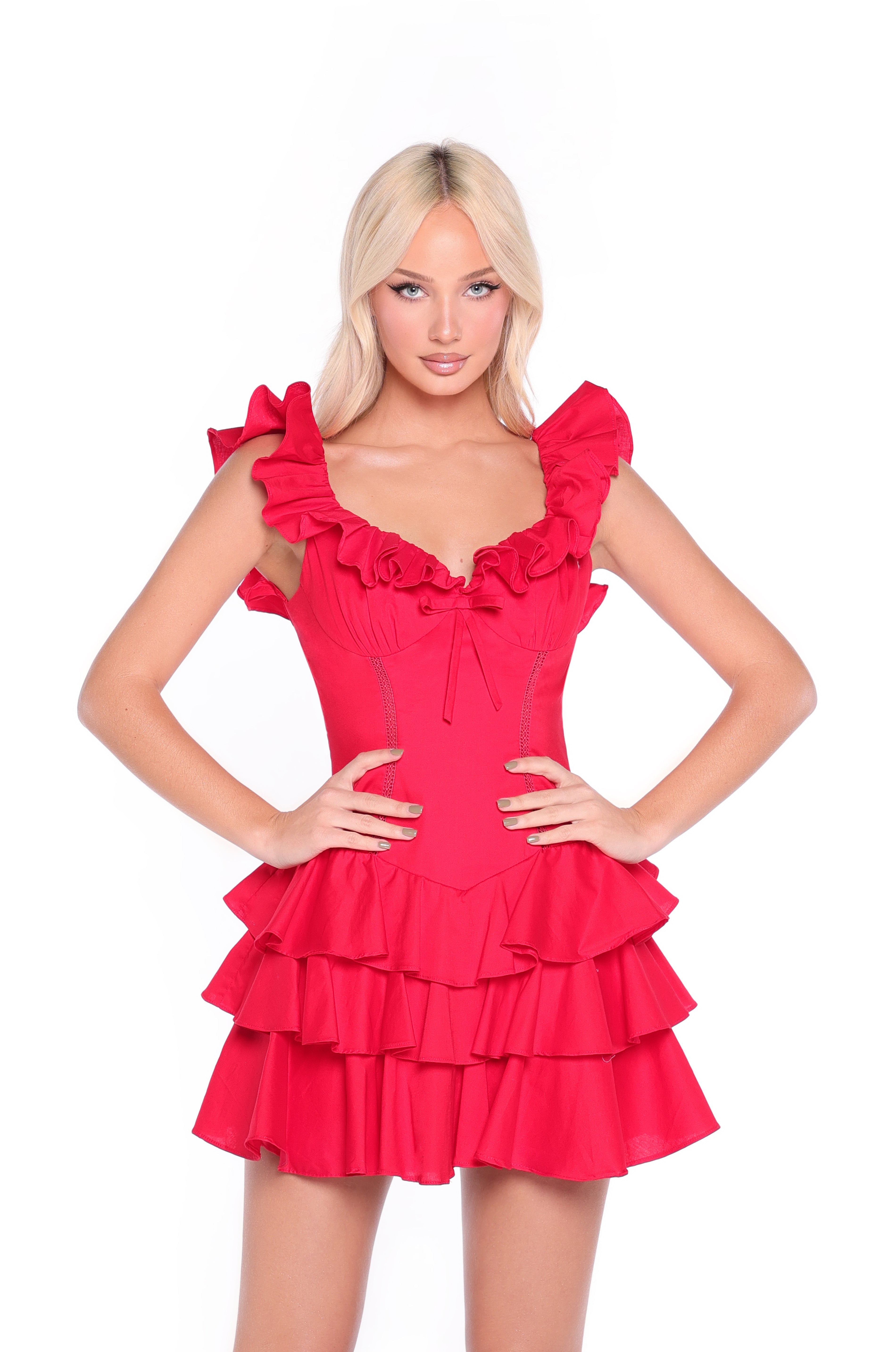 A woman models the Marilyn Ruffled Short Red Casual Party Dress, featuring tiered layers and sleeveless ruffles, standing with hands on hips against a plain white background.